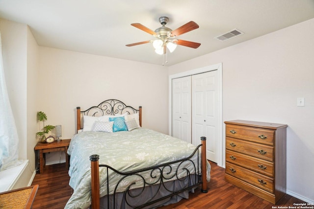bedroom with baseboards, a closet, a ceiling fan, visible vents, and dark wood finished floors