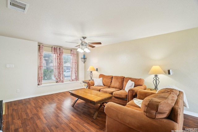 living area featuring wood finished floors, baseboards, a ceiling fan, and visible vents