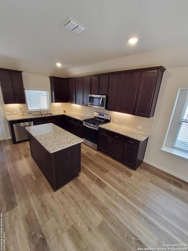 1976 Cowan Dr, New Braunfels, TX 78132 - kitchen featuring stainless steel appliances, a kitchen island, visible vents, and light wood finished floors