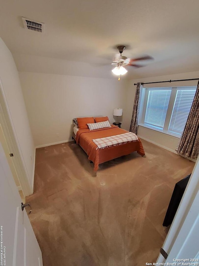 1976 Cowan Dr, New Braunfels, TX 78132 - carpeted bedroom featuring a ceiling fan, baseboards, and visible vents