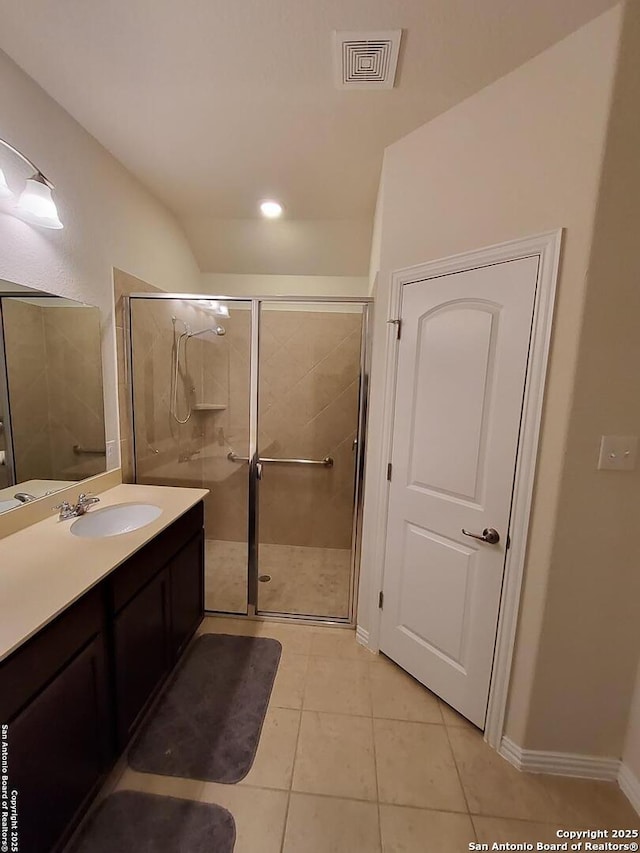 1976 Cowan Dr, New Braunfels, TX 78132 - bathroom with vanity, baseboards, visible vents, a stall shower, and tile patterned flooring