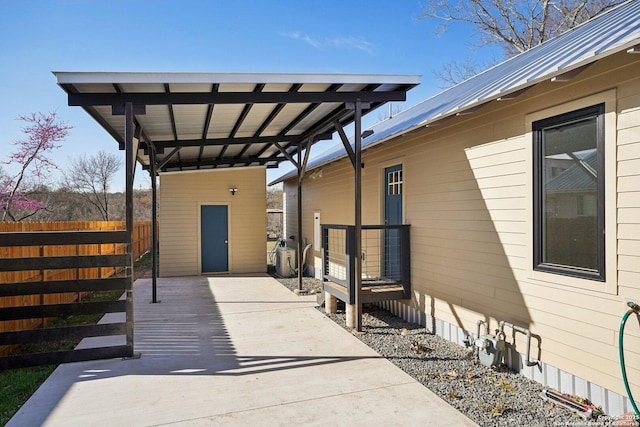 exterior space with an outdoor structure, fence, and driveway