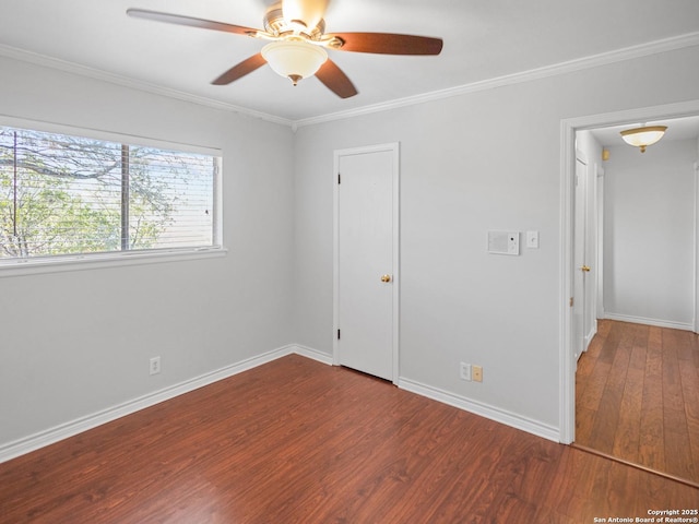 unfurnished bedroom with ceiling fan, baseboards, wood finished floors, and ornamental molding