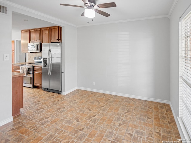 kitchen featuring crown molding, stainless steel appliances, light countertops, and a ceiling fan