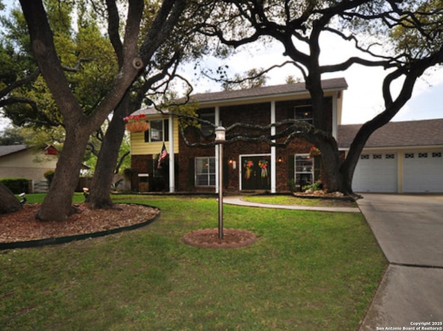 view of front of home featuring concrete driveway, an attached garage, and a front yard