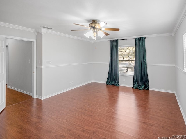 unfurnished room featuring crown molding, wood finished floors, visible vents, and ceiling fan