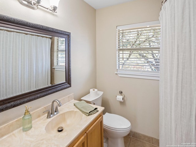 bathroom featuring vanity, tile patterned floors, and toilet