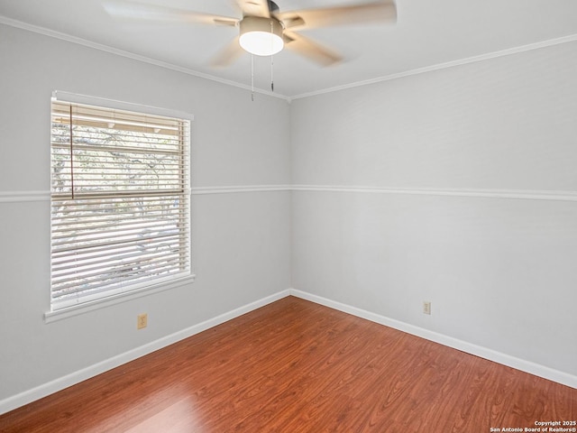 unfurnished room with ornamental molding, wood finished floors, baseboards, and ceiling fan