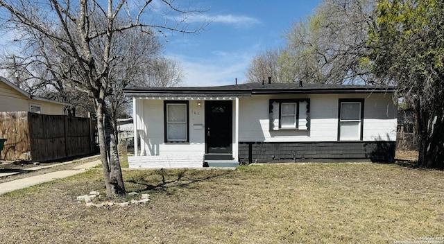 view of front of home with a front lawn and fence
