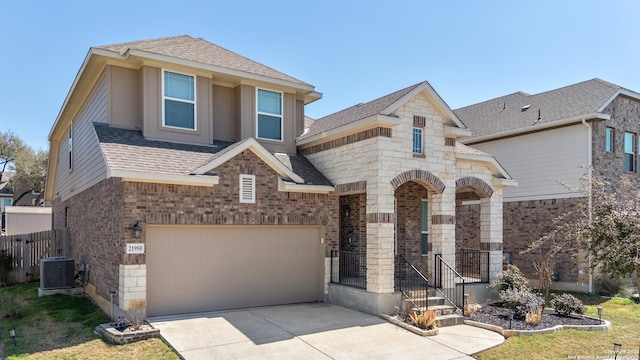 21950 Akin Byu, San Antonio, TX 78261 - view of front of property with central air condition unit, a garage, driveway, and a shingled roof