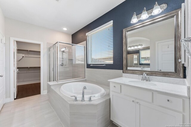 21950 Akin Byu, San Antonio, TX 78261 - bathroom featuring vanity, a garden tub, a stall shower, and a spacious closet