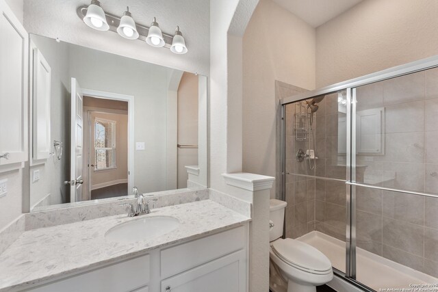 21950 Akin Byu, San Antonio, TX 78261 - bathroom featuring vanity, toilet, and a shower stall