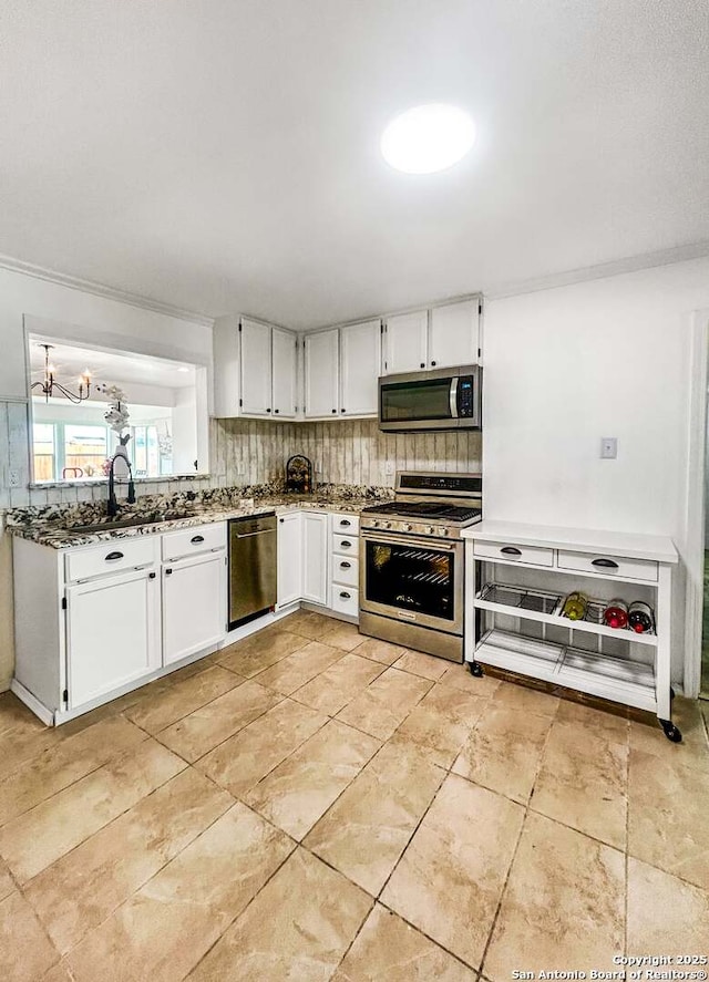 231 Cicero, San Antonio, TX 78218 - kitchen featuring stainless steel appliances, a sink, white cabinets, stone countertops, and backsplash