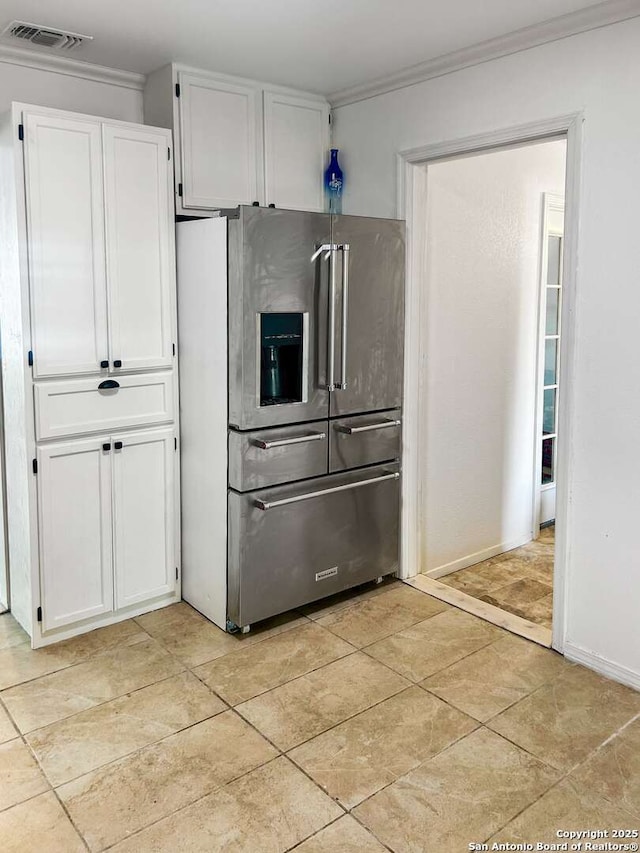 231 Cicero, San Antonio, TX 78218 - kitchen with stainless steel refrigerator with ice dispenser, white cabinetry, ornamental molding, and baseboards