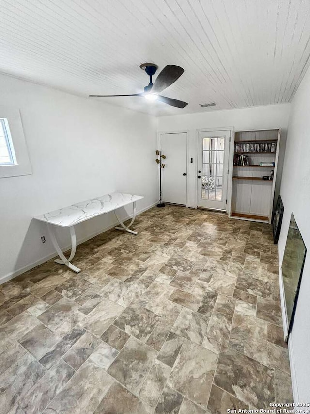 231 Cicero, San Antonio, TX 78218 - interior space with a ceiling fan, stone finish flooring, and baseboards