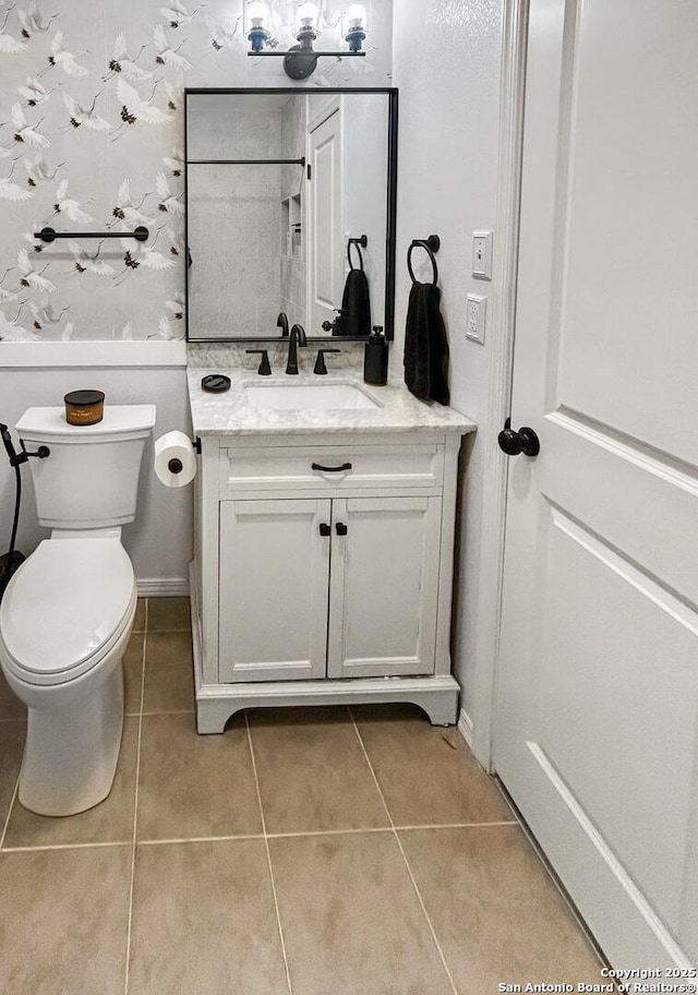 231 Cicero, San Antonio, TX 78218 - bathroom with tile patterned floors, toilet, and vanity