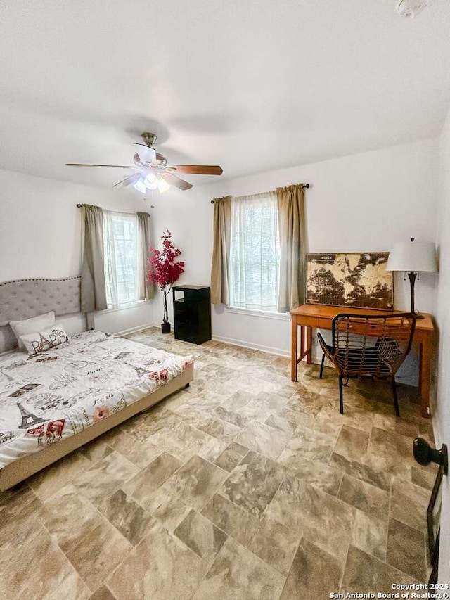231 Cicero, San Antonio, TX 78218 - bedroom with multiple windows, stone finish flooring, and a ceiling fan
