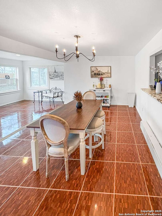231 Cicero, San Antonio, TX 78218 - dining space featuring a chandelier, baseboards, and dark tile patterned floors