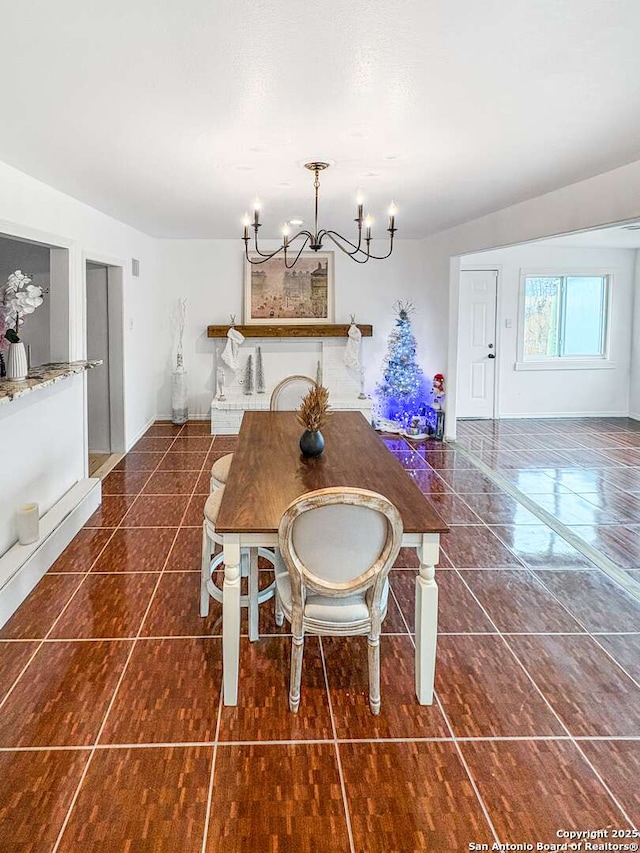 231 Cicero, San Antonio, TX 78218 - tiled dining room featuring a chandelier and baseboards