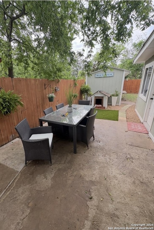 231 Cicero, San Antonio, TX 78218 - view of patio / terrace with outdoor dining area, a fenced backyard, and an outbuilding