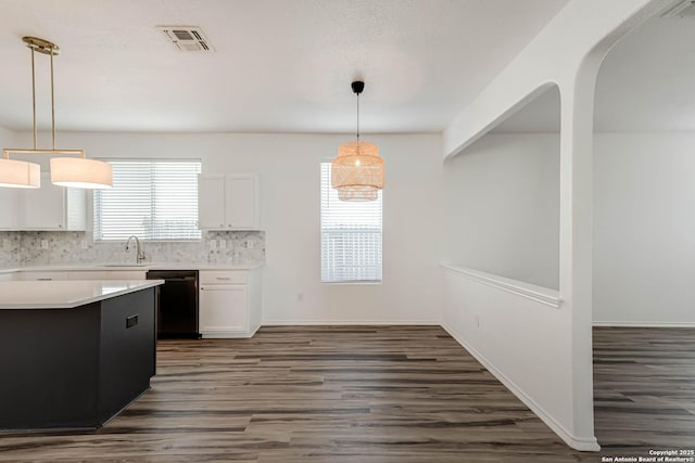7519 Paraiso Hvn, Boerne, TX 78015 - kitchen with visible vents, light countertops, black dishwasher, white cabinetry, and a sink