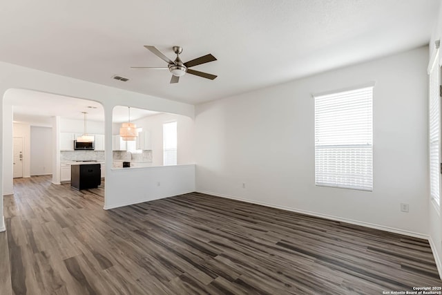 7519 Paraiso Hvn, Boerne, TX 78015 - unfurnished living room with dark wood finished floors, visible vents, baseboards, and a ceiling fan