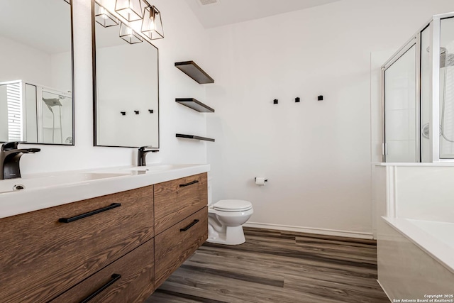 7519 Paraiso Hvn, Boerne, TX 78015 - full bathroom featuring toilet, a stall shower, vanity, and wood finished floors