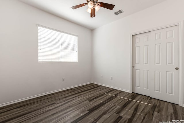 7519 Paraiso Hvn, Boerne, TX 78015 - unfurnished bedroom featuring baseboards, visible vents, ceiling fan, dark wood-type flooring, and a closet
