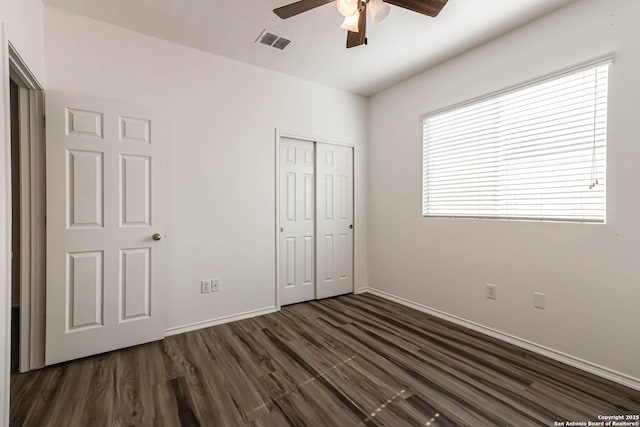 7519 Paraiso Hvn, Boerne, TX 78015 - unfurnished bedroom with baseboards, visible vents, ceiling fan, dark wood-type flooring, and a closet