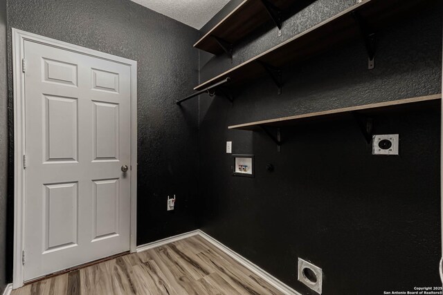 7519 Paraiso Hvn, Boerne, TX 78015 - clothes washing area with electric dryer hookup, light wood-type flooring, hookup for a washing machine, and laundry area