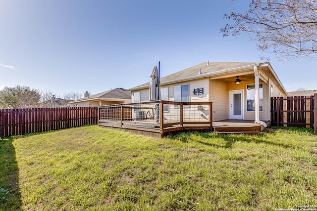 7519 Paraiso Hvn, Boerne, TX 78015 - rear view of house with a deck, a ceiling fan, a fenced backyard, a yard, and a garage