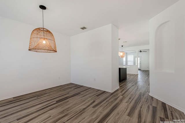 7519 Paraiso Hvn, Boerne, TX 78015 - spare room with visible vents, ceiling fan with notable chandelier, baseboards, and wood finished floors
