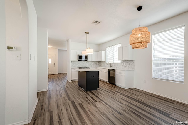 7519 Paraiso Hvn, Boerne, TX 78015 - kitchen featuring visible vents, decorative backsplash, dishwasher, stainless steel microwave, and a center island