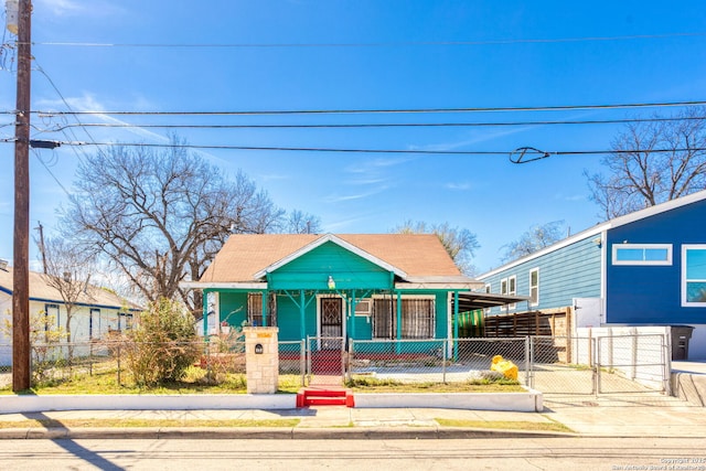 view of front of home with a fenced front yard and a gate