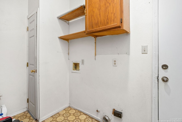 laundry room featuring baseboards, light floors, washer hookup, hookup for a gas dryer, and cabinet space