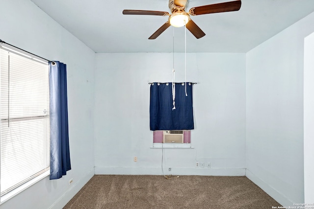 carpeted spare room with cooling unit, baseboards, and ceiling fan
