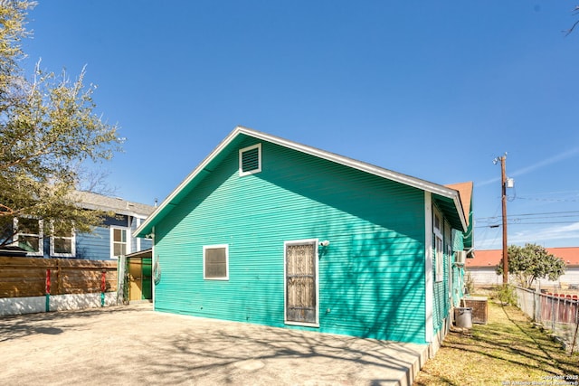 rear view of property featuring fence