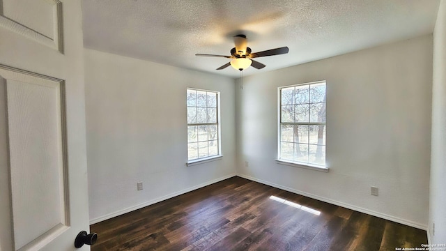 unfurnished room featuring a ceiling fan, dark wood-style floors, baseboards, and a textured ceiling
