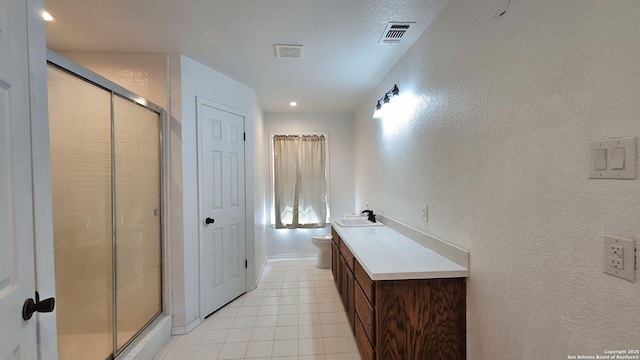 full bath featuring a shower stall, a textured wall, and visible vents