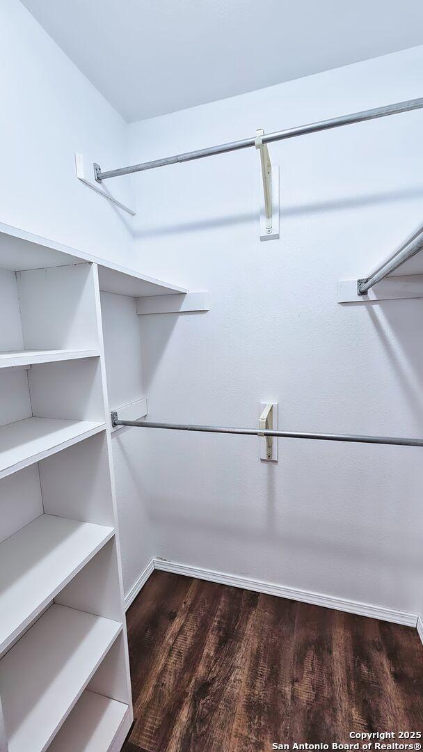 spacious closet with wood finished floors