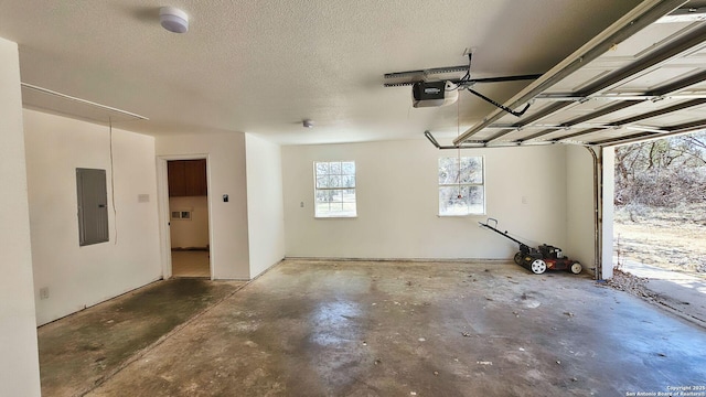 garage with electric panel and a garage door opener