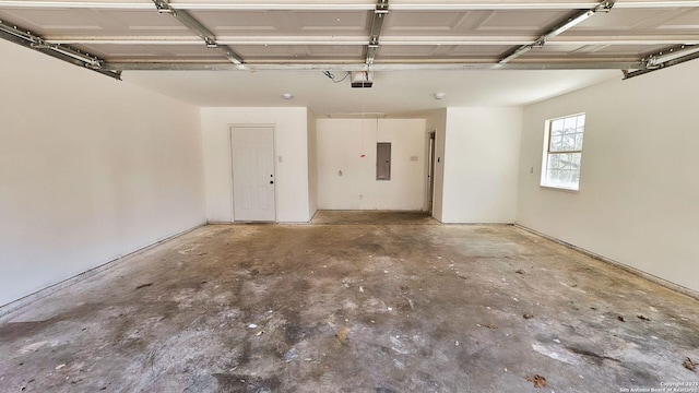 garage featuring electric panel and a garage door opener