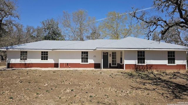 single story home featuring metal roof