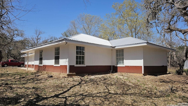 view of property exterior featuring metal roof