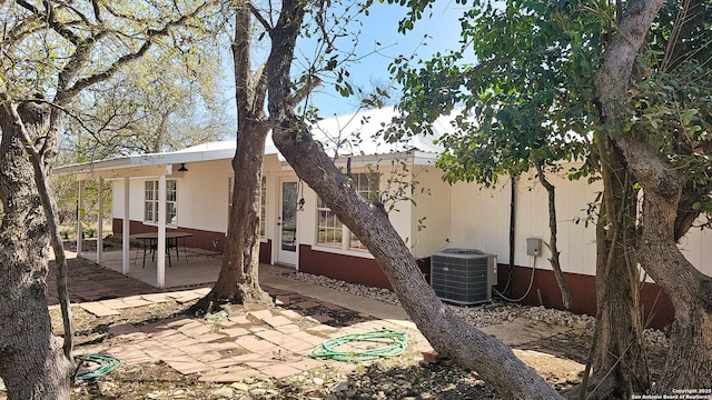 back of property with a patio and central AC