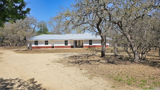 ranch-style house with metal roof and a porch