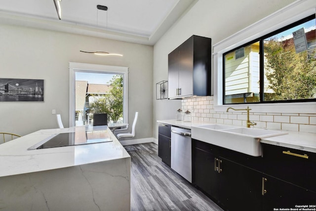 kitchen with dark cabinets, a sink, black electric stovetop, dishwasher, and plenty of natural light