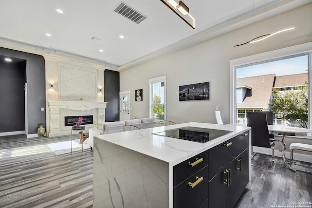 kitchen with dark cabinets, black electric cooktop, plenty of natural light, dark wood-style floors, and recessed lighting