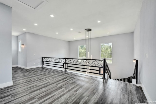 unfurnished room with baseboards, wood finished floors, and recessed lighting