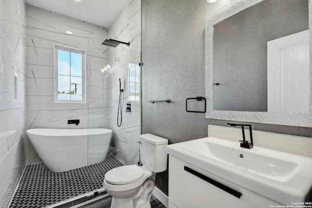 full bath featuring toilet, a freestanding bath, a shower, and vanity